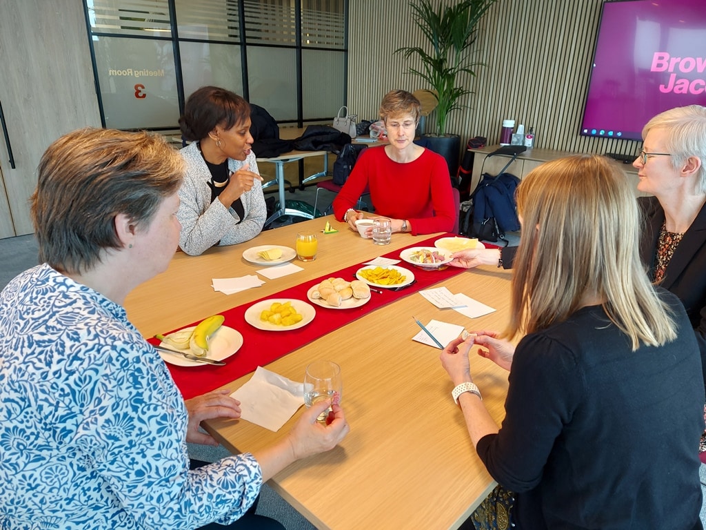 CityWomen meet together over food.